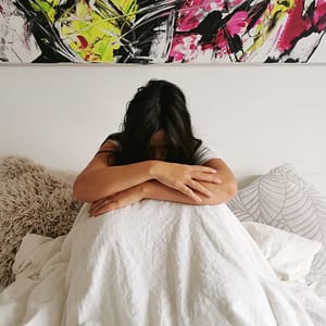 woman in bed with depression